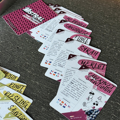 Set of Mistral WineCards Grape playing cards with various designs and text on a dark surface
